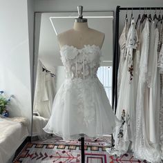 a white dress is on display in a room