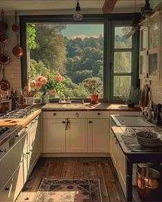 a kitchen filled with lots of counter top space next to an open window overlooking the forest