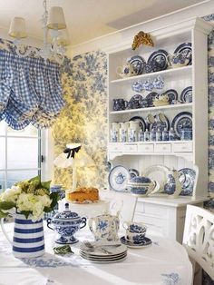 a dining room table with blue and white china