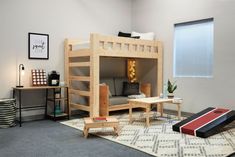 a bunk bed in the corner of a room with a couch and coffee table underneath it