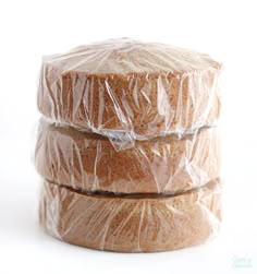 three pieces of bread wrapped in plastic sitting on top of each other next to each other