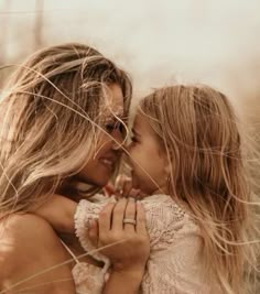 two beautiful young women hugging each other