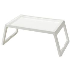 a white coffee table sitting on top of a white floor