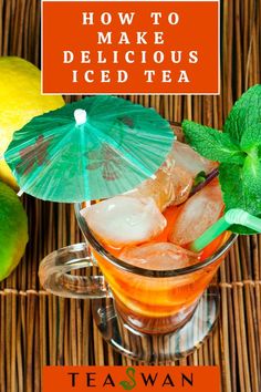 iced tea in a glass mug with an umbrella and lime on the rim next to it