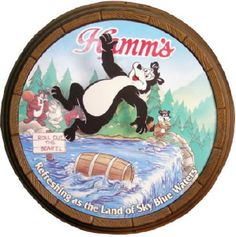 a round wooden plaque with an image of a panda jumping over a river and other cartoon characters