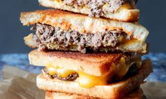 three cheeseburger sandwiches stacked on top of each other