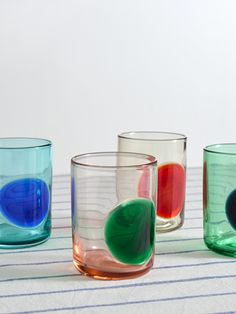 four different colored glasses sitting on top of a table