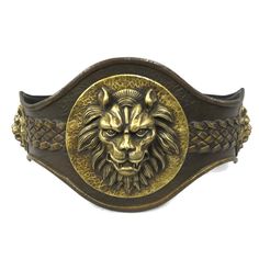 a brass lion head belt buckle with braiding around it's sides, on a white background