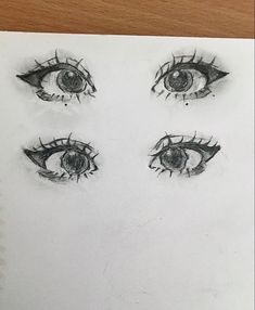 a drawing of three eyes with one eye opened and the other half closed, on top of a piece of paper