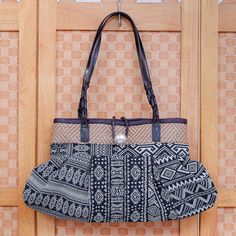 With its patchwork of black and white geometric designs Thai artisan Chirada's shoulder bag makes a bold impression. Hand crafted from a poly-cotton blend the bag features a woven geometric motif in a kaleidoscope of color braided leather straps and a button closure with a decorative aluminum bauble. Inside a cotton lining cushions your belongings while one zippered pocket and two open pockets give you a place for knickknacks. Black Square Canvas Shoulder Bag, Black Fabric Shoulder Bag For Everyday Use, Woven Fabric Bags For Everyday Use, Black Cotton Rectangular Shoulder Bag, Everyday Woven Fabric Shoulder Bag, Black Canvas Rectangular Hobo Bag, Black Cotton Hobo Tote Bag, Rectangular Black Cotton Shoulder Bag, Black Fabric Bags For Daily Use