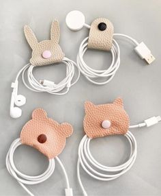 four cell phones with ear buds attached to the headset and cords connected to them