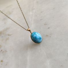 ITEM DESCRIPTION: >>The pendant is made from Solid 14K Yellow Gold. Gemstone used is absolutely natural and ethically sourced. >>Natural Larimar in cabochon cut and oval shape with bezel setting is studded on it with utmost precision. >>This is a minimalist design and is absolutely hassle-free and everyday jewelry. Gem: Larimar Gem size: 12x16 mm Gem weight: 9.54 carats Gold purity: 14K (58.33% approx.) Gold weight: 0.51 grams Gross weight: 2.42 grams The Gold purity is guaranteed and it comes w Oval Blue Larimar Jewelry, Oval Larimar Jewelry For Anniversary, Larimar Pendant, March Birthstone, Birthstone Pendant, Oval Pendant, March Birth Stone, Gold Pendant Necklace, Everyday Jewelry