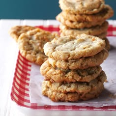 a stack of cookies sitting on top of a red and white checkered table cloth