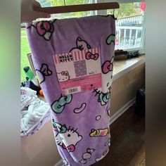 a hello kitty towel hanging on a clothes rack