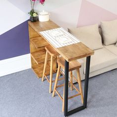 three stools and a table in front of a couch