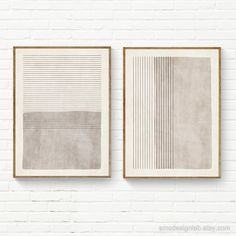 two framed art pieces on a white brick wall, each with different lines and shapes