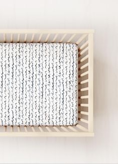 an overhead view of a baby's crib with blue and white designs on it