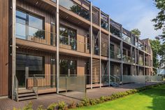 the building has many windows and balconies on each floor, along with glass railings