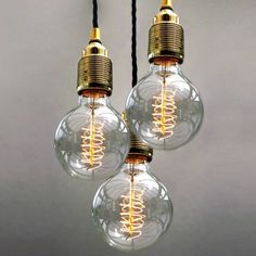 three light bulbs that have been turned on to look like they are hanging from wires