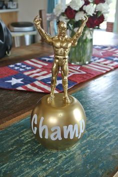 a gold statue on top of a wooden table