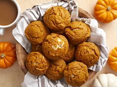 pumpkin muffins in a basket next to a cup of coffee