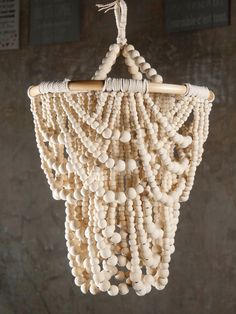 a wooden beaded chandelier hanging from a ceiling