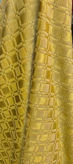 two pieces of yellow fabric sitting next to each other