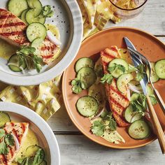 three plates with grilled salmon and cucumbers on them