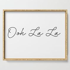 the word oh la la is written in cursive handwriting on a white background