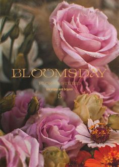 the front cover of blooming day, with pink roses and daisies in it