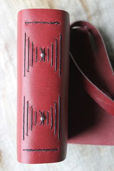 a red leather case sitting on top of a table