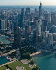 an aerial view of a large city with lots of tall buildings in the middle of it