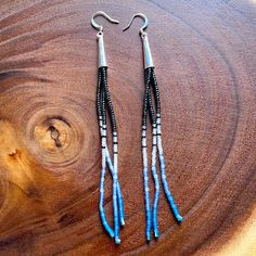 Blue Lagoon - Long Bead Drop Earrings Description: Brand New, Hand Made By Me. Beads Are A Combination Of Gunmetal Grey, Matte Clear, And Shades Of Blue Glass Seed Beads (Done In A Color Gradient) With Silver Tone Cone Caps On Top. Length: Just A Little Over 5 Inches Long From Top Of Hook To Bottom Of Last Bead. Let Me Know If You Have Any Questions. Tags: #Brickstitchearrings #Handmade #Lotusearrings #Longearrings #Seedbeadearrings Simple Bead Earrings, Dark Earrings, Long Beaded Earrings, Native Earrings, Beaded Projects, Bead Drop Earrings, Silver Star Earrings, Lotus Earrings, Costume Jewelry Sets