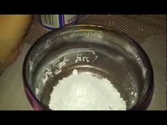 a metal bowl filled with white powder next to a can