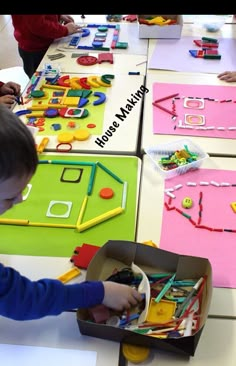 children are playing with construction toys on the table at a preschool - sized schoolroom