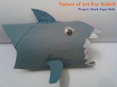 a sculpture of a shark made out of construction paper