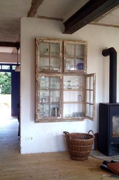 an old window is hung on the wall next to a basket and fire hydrant