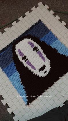 a knitted rug with a cartoon character on it