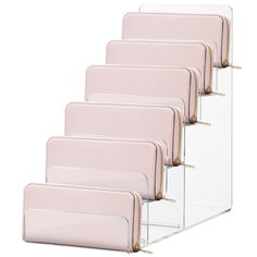 six clear acrylic files with gold handles and zipper closures on each side