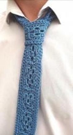 the man is wearing a blue crocheted tie