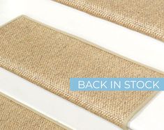 a carpeted stair tread with the words back in stock on it