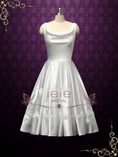 a white dress on a mannequin dummy with purple wallpaper in the background