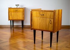 two small wooden nightstands sitting side by side on top of a hard wood floor