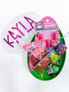 a green tray with candy, candies and an oval sign that says kayla