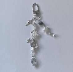 a close up of a key chain with charms on it's end and an animal charm hanging from the side