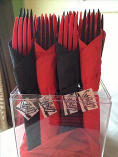 red and black folded napkins in a clear box