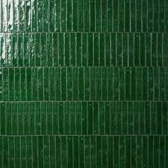 a green tile wall that is very close to the ground and has lines on it