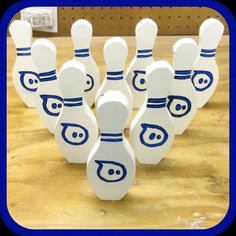 a group of bowling pins sitting on top of a wooden table