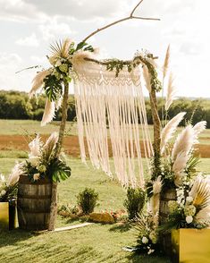 an outdoor ceremony setup with flowers and feathers