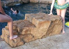 some people are in the water and one is standing on steps to get into the pool